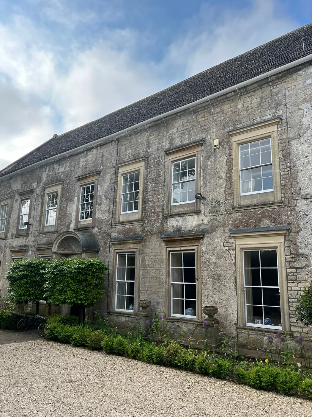 Restored heritage stone property with sash windows and landscaped frontage
